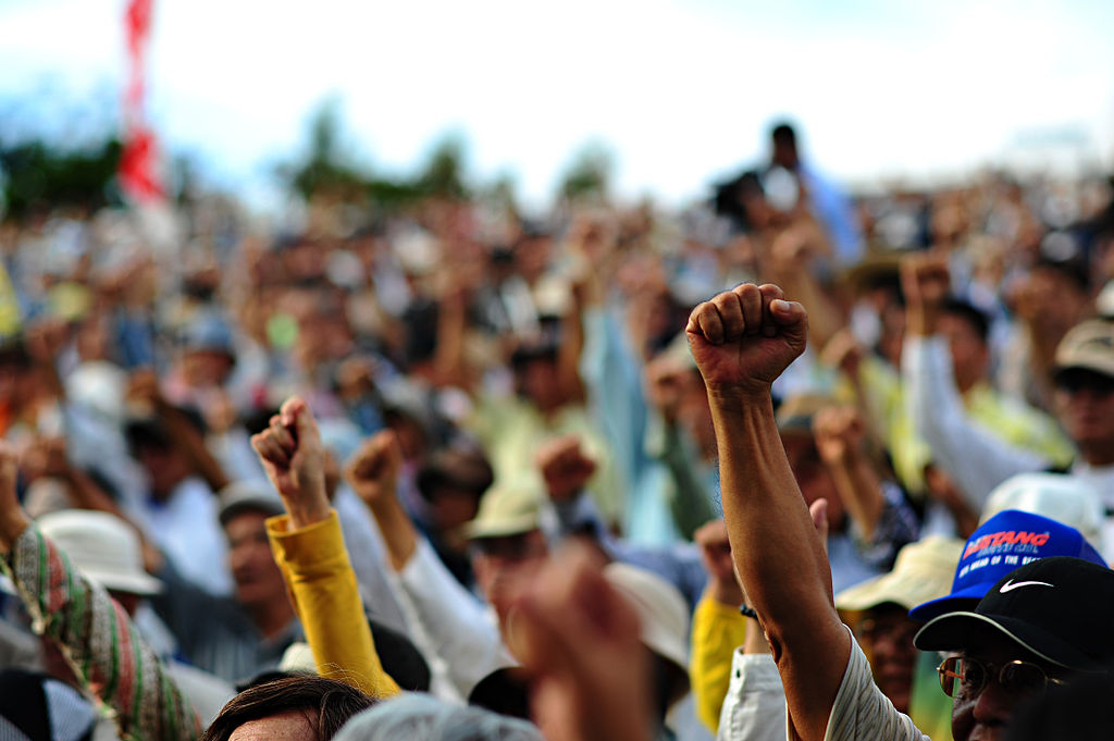 1024px-Closeup_of_protesters_at_Ginowan_protests_2009-11-08